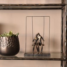 Couple Sitting on a Swing Sculpture